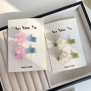 Handmade floral hair clips set for girls featuring pink and white resin petals on clips