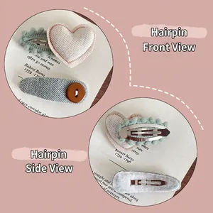 Two-piece embroidered fabric hair clips set with heart pattern and textured bow for girls