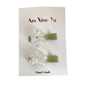 Sweet floral hair clips for girls with white petals and green satin duckbill clips