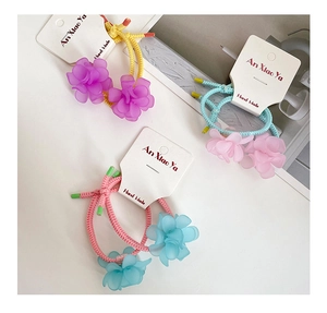 Close-up of three colorful resin flower hair ties with high elasticity on display card