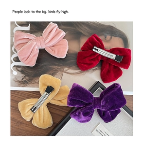Detailed view of handmade velvet bow hair clips in four elegant colors with duckbill clips