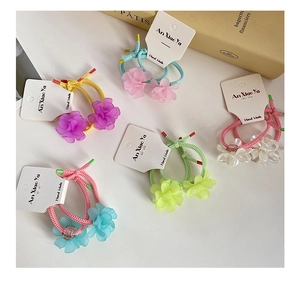 Detailed view of colorful floral hair ties set on white display cards for styling