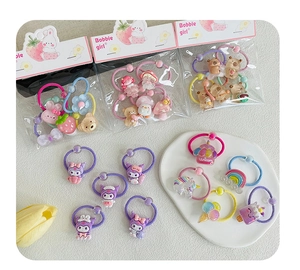 Close-up of colorful cartoon resin hair bands with unicorn and strawberry designs on card