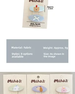 Detailed view of handmade cartoon bear fabric hair clips with specific size measurements