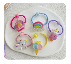 Detailed view of 5-piece girls' cartoon hair bands including unicorn and rainbow charms