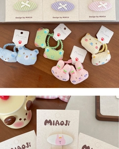 Close-up of cute cartoon bear and rabbit fabric hair clips with colorful knit bows