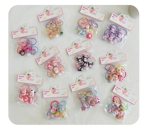 Detail view of various colorful cartoon hair ties and elastic bands for kids