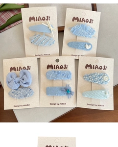 Detailed view of handmade light blue tweed and chiffon bow hair clips set for girls