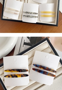 Detail of elegant acetate leaf hair clips in tortoiseshell and beige on display