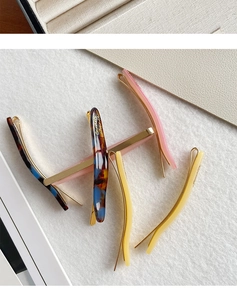 Detailed macro shot of acetate hair clips with Tortoise and pastel marble textures