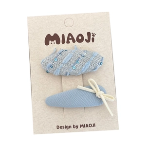 Blue tweed hair clip set with lace bow and sequins on elegant display card
