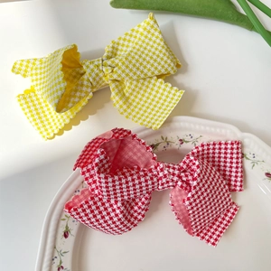 Sweet plaid bow hair clips with ruffled edges in yellow and red gingham patterns