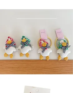 Handmade plush duck hair clip and scrunchie set with cute checkered fabric details