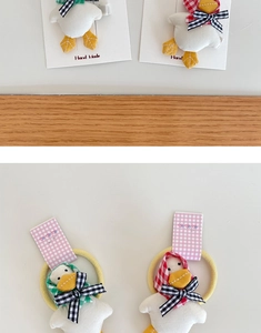 Detailed view of handmade plush duck hair clips and ties with cute plaid bandanas