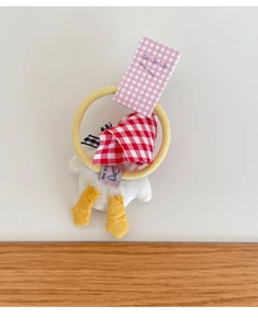 Detailed view of handmade plush duck hair tie with cute red and white gingham fabric detail