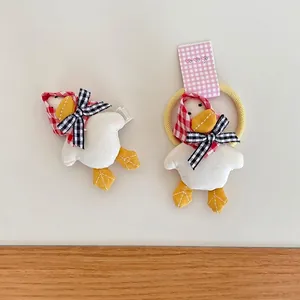 Handmade plush duck hair clip and elastic tie set with checkered bow details for girls