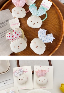 Detail of handmade rabbit hair clips and ties with floral patterns on a display card
