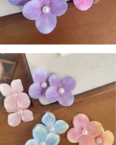 Detailed view of handmade gradient orchid petals and center pearl hair clip accessories