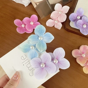 Elegant floral orchid hair clips with pearls in multiple colors for seaside vacations