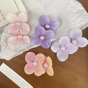 Floral orchid hair clips with pearls in pink and purple for seaside vacation styling