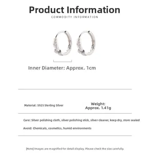 Detail showing S925 sterling silver hoop earrings with 1cm inner diameter and clear specs
