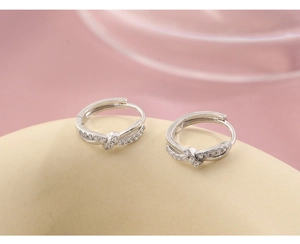 Macro shot of silver twist hoop earrings featuring white micro-inlaid zircon stones