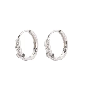 Silver twisted hoop earrings with micro-pave diamonds in a minimalist luxury design