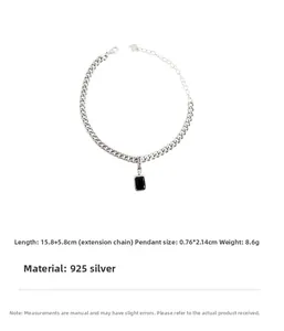 Detail of silver chain bracelet with blue zircon pendant and engraved Lucky tag
