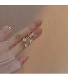 Detail of s925 silver opal butterfly earrings with droplet zircon and gold metal finish