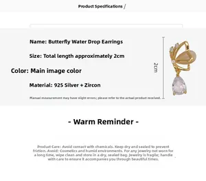 Detail view of gold butterfly stud earrings with clear teardrop zircon and 925 silver