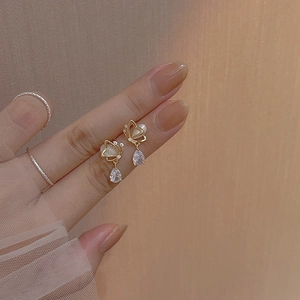 Elegant gold butterfly earrings with white opal wings and teardrop zircon crystal pendants