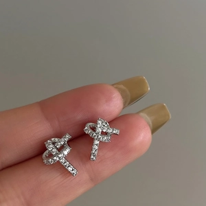 Elegant knotted zircon earrings in silver finish featuring full diamond pave setting