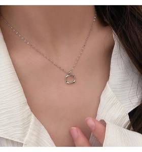 Detail of silver hollow square pendant on model with white striped shirt for summer