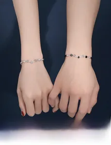 Detailed view of the deer antler couple bracelets with silver chain and black woven rope