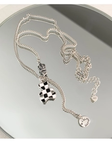Detail of S925 silver necklace with checkered bear pendant and Lucky Star tag