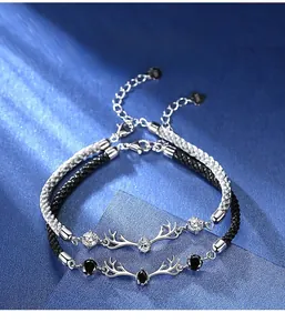 Close-up of S925 deer horn couples bracelets with braided cord and sparkling zircon stones