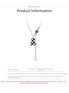 Detail view of S925 silver bear necklace with black and white checkerboard pendant