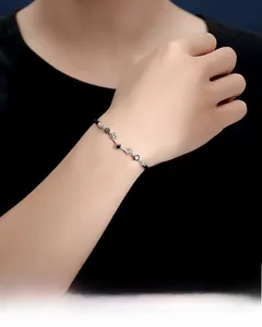 Detail view of couple bracelets featuring deer antler design with black gemstones and woven cord