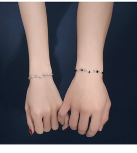 Detailed view of deer antler couple bracelets with silver chain and black woven rope