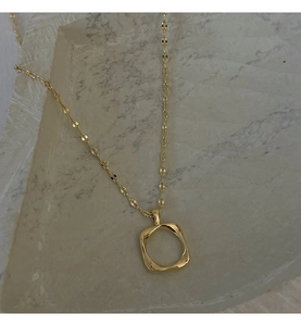 Detailed close-up of a hollow square pendant necklace with polished gold finish