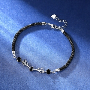 Couples woven deer antler bracelet with black gems on a navy textured background