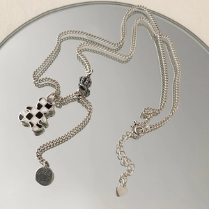 Silver bear pendant necklace with black white checkerboard pattern and crown detail