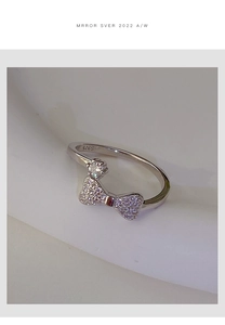 Detailed close-up showing the S925 silver hallmark on the sparkling bow-knot ring band