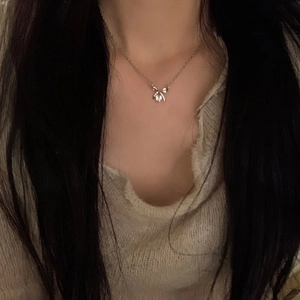 Exquisite silver butterfly pendant necklace with zircon stone worn on a model