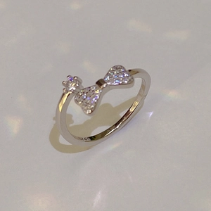 Sparkling S925 silver bow ring with cubic zirconia stars in a minimalist style