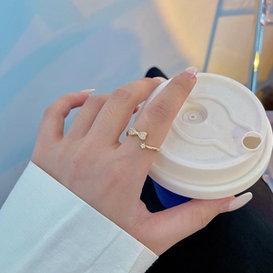 Elegant gold bow open ring for women featuring sparkling zircon and an adjustable band