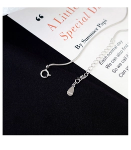 Detailed macro shot of S925 sterling silver snake chain with hallmarked droplet tag