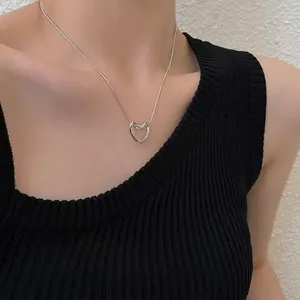 Minimalist silver hollow heart pendant necklace with stylish twist design for women