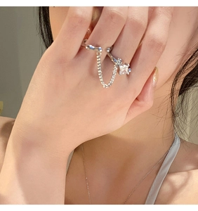 Detail of silver chain ring with square zircon stone shown on model hand