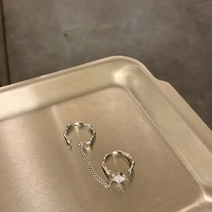 Silver chain cuff earrings with square zircon stone on a metallic tray view